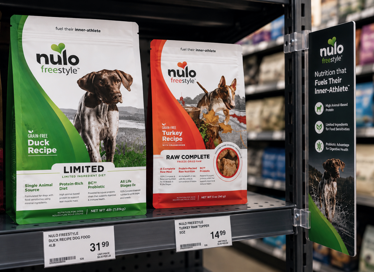 Two Nulo Freestyle dog food bags on a store shelf: green Duck Recipe (grain-free) and red Turkey Recipe (raw complete) with price tags below.