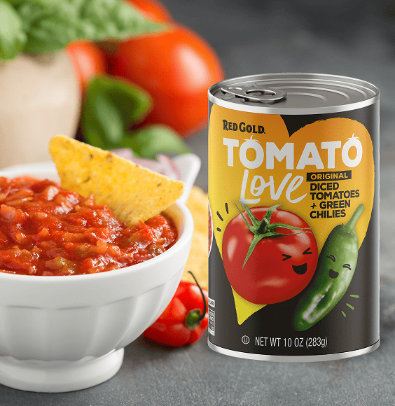 Can of Red Gold Tomato Love diced tomatoes and green chilies beside a bowl of salsa with a tortilla chip.