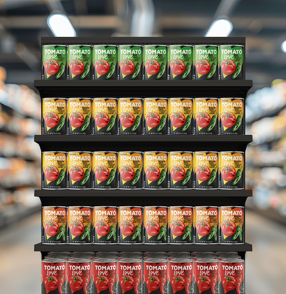 Shelf display of Tomato Love tomato juice cartons in green and orange flavors, arranged in rows on five black shelves in a supermarket.
