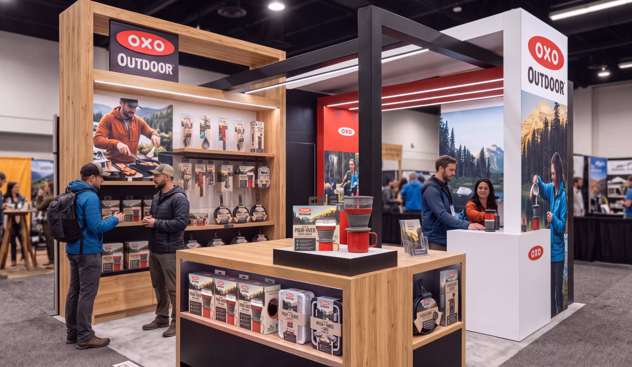 Booth at an outdoor gear trade show featuring OXO Outdoor products on wooden shelves with two men talking in front of the display.