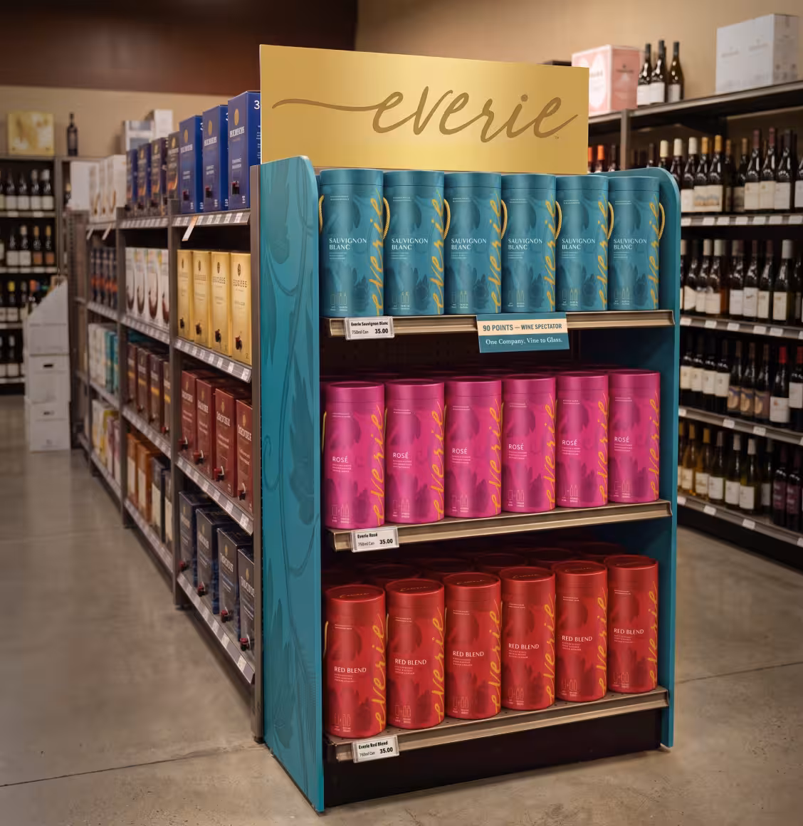Display stand of Everie wines: teal Sauvignon Blanc cans on top, pink Rosé in middle, red blend on bottom in a store aisle.