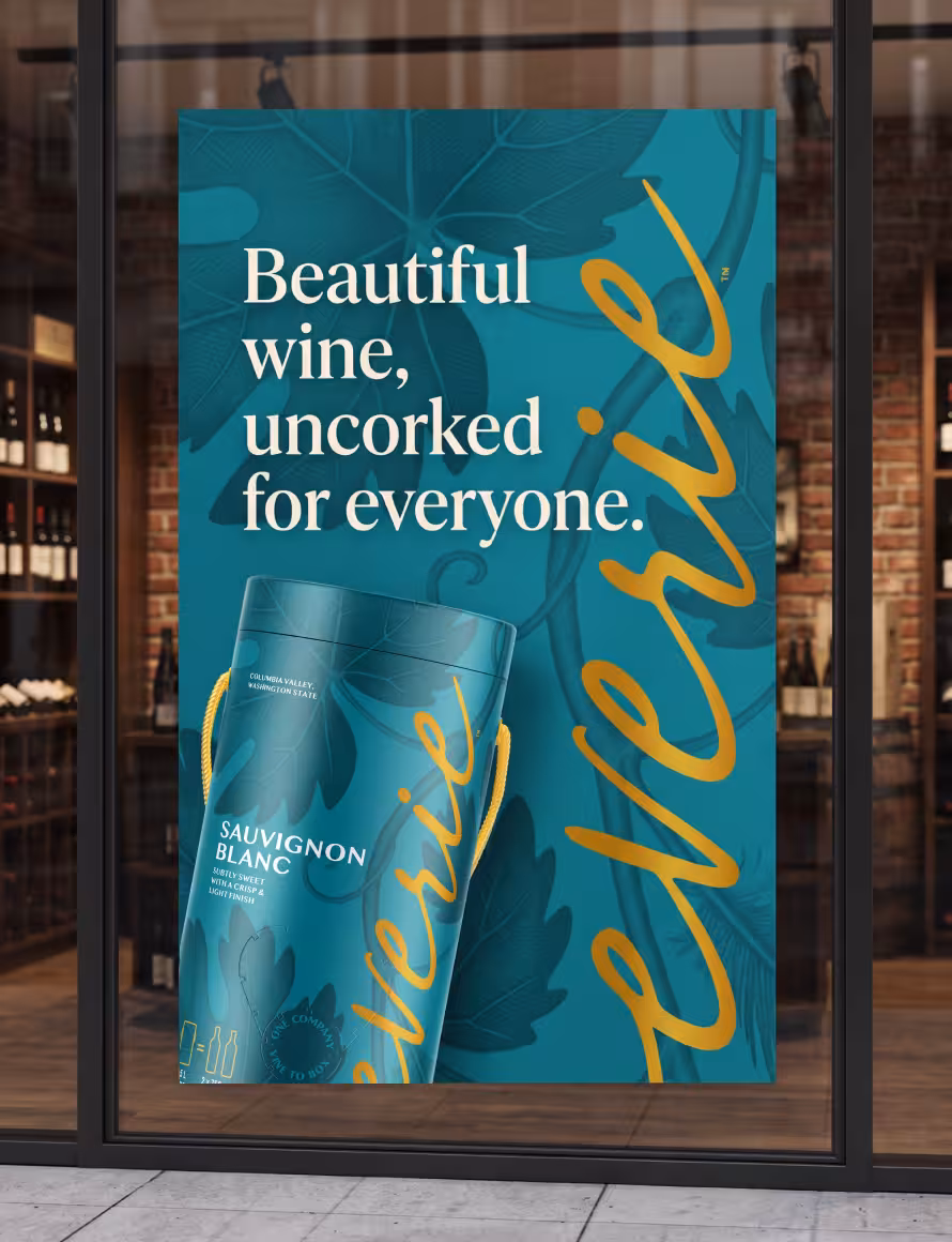 Poster in a storefront window advertising Sauvignon Blanc with a teal background and orange script text.