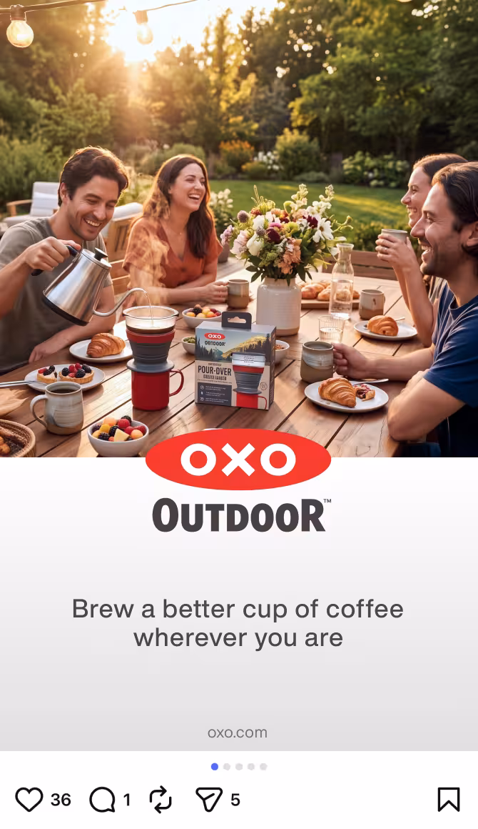 A group of friends sitting around a wooden outdoor table at sunset, sharing coffee and pastries, with a vase of flowers and OXO Outdoor branding visible on the table.
